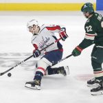 
              Washington Capitals center Nic Dowd (26) controls the puck in front of Minnesota Wild left wing Kevin Fiala (22) during the first period of an NHL hockey game Saturday, Jan. 8, 2022, in St, Paul, Minn. (AP Photo/Andy Clayton-King)
            