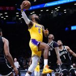 
              Los Angeles Lakers' LeBron James (6) drives past Brooklyn Nets' James Johnson (16) as Cam Thomas (24) watches during the first half of an NBA basketball game Tuesday, Jan. 25, 2022 in New York. (AP Photo/Frank Franklin II)
            