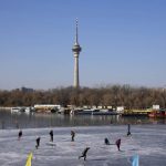 
              Residents skate on a frozen lake in Beijing, China, Tuesday, Jan. 11, 2022. The Chinese capital is on high alert ahead of the Winter Olympics as China locks down a third city elsewhere for COVID-19 outbreak. (AP Photo/Ng Han Guan)
            