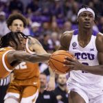 
              TCU forward Emanuel Miller, right, drives past Texas guard Marcus Carr, left, in the first half of an NCAA college basketball game in Fort Worth, Texas, Tuesday, Jan. 25, 2022. (AP Photo/Gareth Patterson)
            