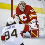 
              Florida Panthers' Ryan Lomberg (94) has his shot stopped by Calgary Flames goalie Jacob Markstrom during the third period of an NHL hockey game Tuesday, Jan. 18, 2022, in Calgary, Alberta. (Jeff McIntosh/The Canadian Press via AP)
            