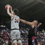 
              Gonzaga center Chet Holmgren, left, goes up for a dunk in front of Loyola Marymount guard Cam Shelton during the first half of an NCAA college basketball game, Thursday, Jan. 27, 2022, in Spokane, Wash. (AP Photo/Young Kwak)
            