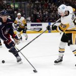 
              Pittsburgh Penguins forward Jake Guentzel, right, shoots the puck next to Columbus Blue Jackets defenseman Gavin Bayreuther during the first period of an NHL hockey game in Columbus, Ohio, Friday, Jan. 21, 2022. Dumoulin scored on the play. (AP Photo/Paul Vernon)
            