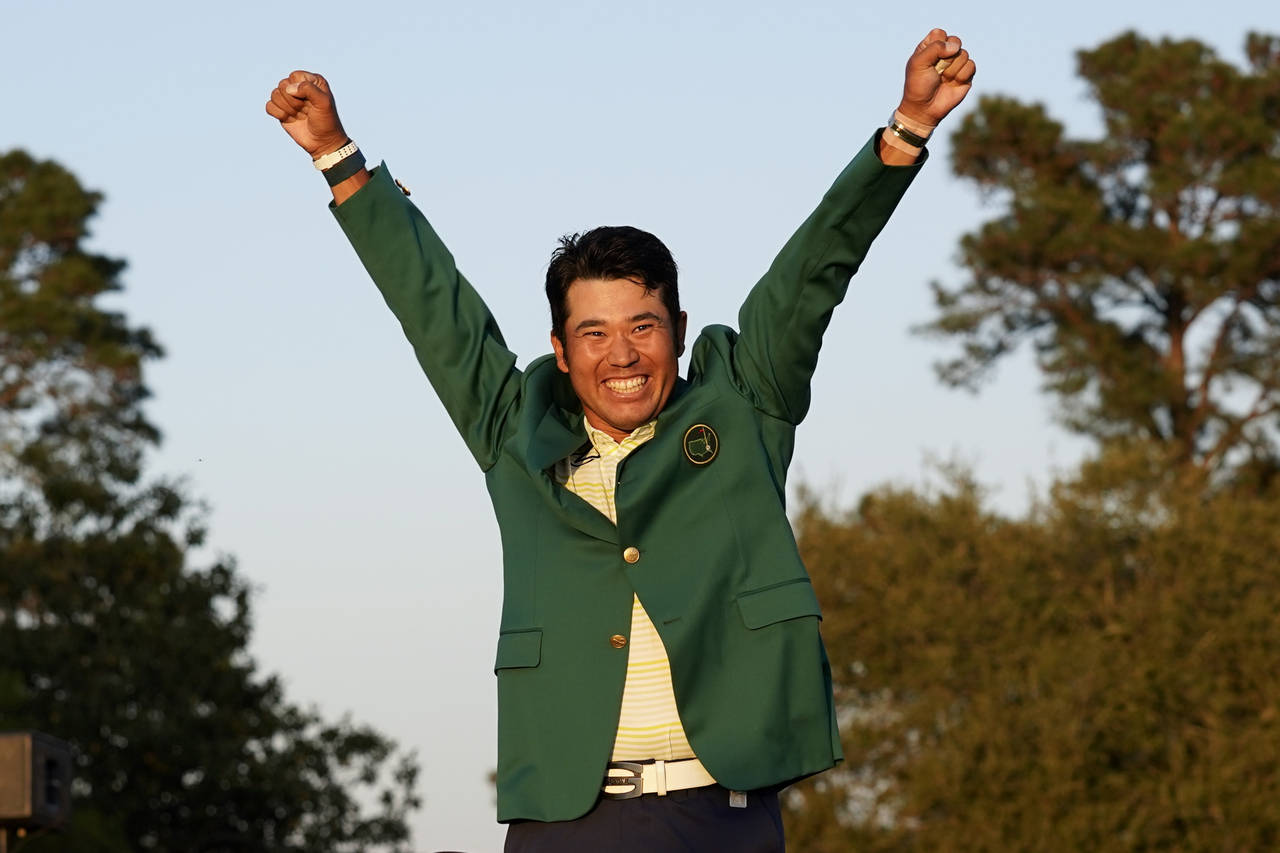 FILE -Hideki Matsuyama of Japan celebrates after putting on the champion's green jacket after winni...