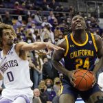 
              California's Sam Alajiki (24) looks to shoot as Washington's Emmitt Matthews Jr. (0) defends in the first half of an NCAA college basketball game Wednesday, Jan. 12, 2022, in Seattle. (AP Photo/Elaine Thompson)
            