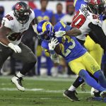 
              Los Angeles Rams running back Cam Akers (23) goes down in front of Tampa Bay Buccaneers defensive end William Gholston (92) during the second half of an NFL divisional round playoff football game Sunday, Jan. 23, 2022, in Tampa, Fla. (AP Photo/Mark LoMoglio)
            
