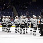 
              The Los Angeles Kings line up to shake hands with referee Dean Morton (26) after an NHL hockey game against the New York Islanders on Thursday, Jan. 27, 2022, in Elmont, N.Y. The Kings won 3-2. (AP Photo/Adam Hunger)
            