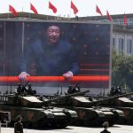 
              FILE - Chinese President Xi Jinping is displayed on a screen as Type 99A2 Chinese battle tanks take part in a parade commemorating the 70th anniversary of Japan's surrender during World War II, held in front of Tiananmen Gate in Beijing on Thursday, Sept. 3, 2015. From the military suppression of Beijing’s 1989 pro-democracy protests to the less deadly crushing of Hong Kong’s opposition four decades later, China’s long-ruling Communist Party has demonstrated a determination and ability to stay in power that is seemingly impervious to Western criticism and sanctions. (AP Photo/Ng Han Guan, File)
            
