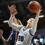 
              Butler forward Alex Richard, right, shoots in front of Connecticut forward Dorka Juhasz in the second half of an NCAA college basketball game in Indianapolis, Wednesday, Jan. 12, 2022. UConn won 92-47. (AP Photo/AJ Mast)
            