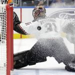 
              The puck passes behind Arizona Coyotes goaltender Scott Wedgewood (31) during the second period of the team's NHL hockey game against the New York Islanders, Friday, Jan. 21, 2022, in Elmont, N.Y. (AP Photo/Corey Sipkin).
            
