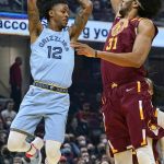 
              Memphis Grizzlies' Ja Morant (12) looks to pass against Cleveland Cavaliers' Jarrett Allen (31) in the first half of an NBA basketball game, Tuesday, Jan. 4, 2022, in Cleveland. (AP Photo/Tony Dejak)
            