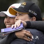 
              Danielle Kang, left, is congratulated by Inbee Park, of South Korea, on the 18th green after Kang won the Tournament of Champions LPGA golf tournament, Sunday, Jan. 23, 2022, in Orlando, Fla. (AP Photo/Phelan M. Ebenhack)
            