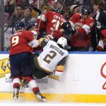 
              Florida Panthers center Sam Bennett (9) and Vegas Golden Knights defenseman Zach Whitecloud (2) go into the boards during the second period of an NHL hockey game, Thursday, Jan. 27, 2022, in Sunrise, Fla. (AP Photo/Lynne Sladky)
            