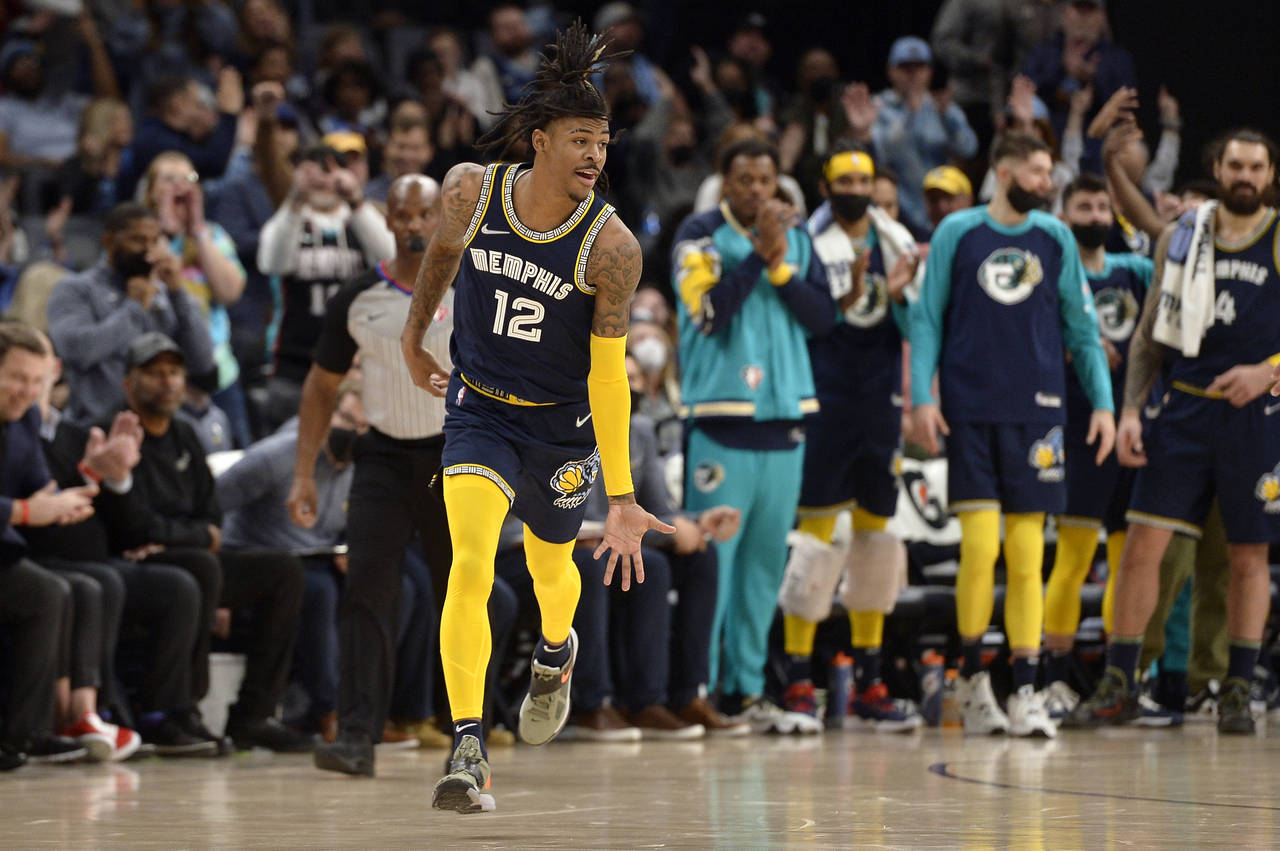 Memphis Grizzlies guard Ja Morant (12) reacts in the second half of an NBA basketball game against ...