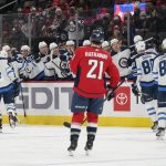
              Members of the Winnipeg Jets celebrate Cole Perfetti's goal as Washington Capitals right wing Garnet Hathaway (21) looks on in the first period of an NHL hockey game, Tuesday, Jan. 18, 2022, in Washington. (AP Photo/Patrick Semansky)
            