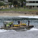 
              FILE - A group of Vietnamese asylum seekers are taken by barge to a jetty on Australia's Christmas Island on April 14, 2013. To people watching from afar, the treatment of tennis star Novak Djokovic by Australian immigration officials might have seemed harsh. But Australia has long taken a severe stance on immigration, from the early days of its "White Australia" policy to its more recent practice of warehousing refugees in offshore detention camps. Many of its policies have been condemned by critics. (AP Photo, File)
            