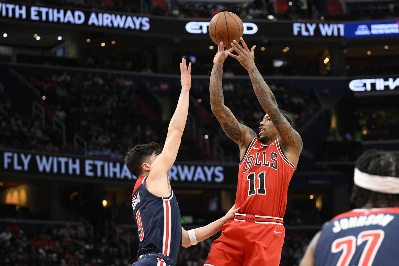 Chicago Bulls forward DeMar DeRozan (11) shoots against Washington Wizards forward Deni Avdija (9) ...