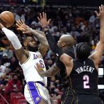 
              Los Angeles Lakers forward LeBron James (6) attempts to pass the ball as Miami Heat forward P.J. Tucker, center, and guard Gabe Vincent (2) defend during the first half of an NBA basketball game, Sunday, Jan. 23, 2022, in Miami. (AP Photo/Lynne Sladky)
            