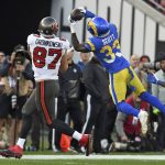 
              Los Angeles Rams safety Nick Scott (33) intercepts a pass intended for Tampa Bay Buccaneers tight end Rob Gronkowski (87) during the first half of an NFL divisional round playoff football game Sunday, Jan. 23, 2022, in Tampa, Fla. (AP Photo/Jason Behnken)
            