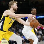 
              Indiana Pacers center Domantas Sabonis (11) grabs the ball next to Oklahoma City Thunder guard Shai Gilgeous-Alexander, right, in the first half of an NBA basketball game Friday, Jan. 28, 2022, in Oklahoma City. (AP Photo/Nate Billings)
            