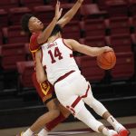 
              Southern California guard Boogie Ellis (0), left, defends Stanford forward Spencer Jones (14) as he drives for the basket during the first half of an NCAA college basketball game Tuesday, Jan. 11, 2022, in Stanford, Calif. (AP Photo/Josie Lepe)
            