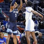 
              Villanova guard Justin Moore, left, shoots against DePaul guard Javon Freeman-Liberty during the first half of an NCAA college basketball game in Chicago, Saturday, Jan. 8, 2022. (AP Photo/Nam Y. Huh)
            