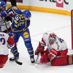 
              FILE - Sweden's Jakob De La Rose, center, makes an attempt to score against Czech Republic's goalie Simon Hrubec during the Channel One Cup ice hockey match between Czech Republic and Sweden in Moscow, Russia, Sunday, Dec. 19, 2021. Former St. Louis, Detroit and Montreal center Jacob de La Rose is expected to play for Sweden at the Olympics after the NHL decided not to send players to Beijing. De La Rose played 259 NHL games.(AP Photo/Alexander Zemlianichenko, File)
            