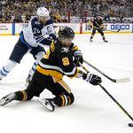 
              Pittsburgh Penguins' Evan Rodrigues (9) gets off a backhand pass with Winnipeg Jets' Blake Wheeler (26) defending during the second period of an NHL hockey game in Pittsburgh, Sunday, Jan. 23, 2022. (AP Photo/Gene J. Puskar)
            