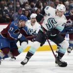 
              Seattle Kraken defenseman Carson Soucy, front right, collects the puck as Colorado Avalanche center Tyson Jost defends in the first period of an NHL hockey game Monday, Jan. 10, 2022, in Denver. (AP Photo/David Zalubowski)
            