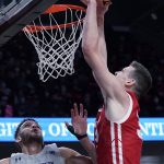 
              Wisconsin center Chris Vogt, right, dunks against Northwestern forward Pete Nance during the first half of an NCAA college basketball game in Evanston, Ill., Tuesday, Jan. 18, 2022. (AP Photo/Nam Y. Huh)
            