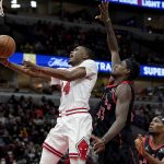 
              Chicago Bulls' Javonte Green (24) scores past Toronto Raptors' Pascal Siakam during the second half of an NBA basketball game Wednesday, Jan. 26, 2022, in Chicago. The Bulls won 111-105. (AP Photo/Charles Rex Arbogast)
            