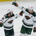 
              Minnesota Wild left wing Marcus Foligno, right, celebrates with right wing Mats Zuccarello after scoring a goal against the Chicago Blackhawks during the first period of an NHL hockey game in Chicago, Friday, Jan. 21, 2022. (AP Photo/Nam Y. Huh)
            