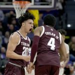 
              Texas A&M guard Andre Gordon (20) reacts with guard Wade Taylor IV (4) during the first half an NCAA college basketball game against LSU in Baton Rouge, La., Wednesday, Jan. 26, 2022. (AP Photo/Matthew Hinton)
            