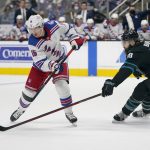 
              New York Rangers center Ryan Strome, left, looks toward the puck in front of San Jose Sharks defenseman Brent Burns during the second period of an NHL hockey game in San Jose, Calif., Thursday, Jan. 13, 2022. (AP Photo/Jeff Chiu)
            