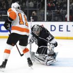 
              Los Angeles Kings goaltender Jonathan Quick (32) blocks a shot in front of Philadelphia Flyers right wing Travis Konecny (11) during the first period of an NHL hockey game Saturday, Jan. 1, 2022, in Los Angeles. (AP Photo/Kyusung Gong)
            