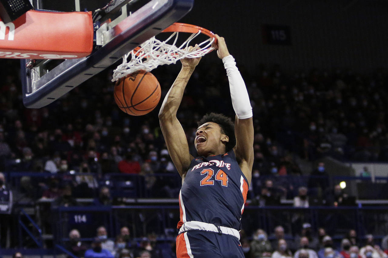 Pepperdine forward Maxwell Lewis dunks during the first half of the team's NCAA college basketball ...
