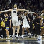 
              Providence's Noah Horchler (14) and Nate Watson (0) celebrate a win over Marquette as Marquette's Justin Lewis (10) walks off the court following an NCAA college basketball game Sunday, Jan. 30, 2022, in Providence, R.I. (AP Photo/Stew Milne)
            