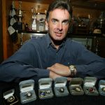 
              FILE - Mike Stefanik poses with his championship rings in front of the trophy case in his Coventry, R.I. home on Tuesday, April 22, 2003. Stefanik will be posthumously inducted into the NASCAR Hall of Fame during  ceremonies in Charlotte, N.C., Friday,  Jan. 21, 2022. (AP Photo/Joe Giblin, File)
            