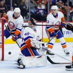 
              New York Islanders' Semyon Varlamov, center, cannot stop a goal by Philadelphia Flyers' Travis Konecny, right, during the second period of an NHL hockey game, Tuesday, Jan. 18, 2022, in Philadelphia. (AP Photo/Matt Slocum)
            