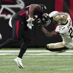 
              Atlanta Falcons running back Mike Davis (28) is hit by New Orleans Saints safety Malcolm Jenkins (27) causing Davis to fumble during the first half of an NFL football game, Sunday, Jan. 9, 2022, in Atlanta. (AP Photo/John Bazemore)
            
