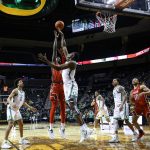 
              Oregon center N'Faly Dante (1) blocks the shot of Utah center Lahat Thioune (0) during the second half of an NCAA college basketball game in Eugene, Ore., Saturday, Jan. 1, 2022. (AP Photo/Thomas Boyd)
            