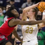 
              Notre Dame's Dane Goodwin (23) gets pressure from North Carolina State's Cam Hayes, left, during the first half of an NCAA college basketball game Wednesday, Jan. 26, 2022, in South Bend, Ind. (AP Photo/Robert Franklin)
            