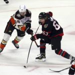 
              Ottawa Senators' Tyler Ennis (63) shoots as Anaheim Ducks' Jamie Drysdale (34) defends during the first period of an NHL hockey game in Ottawa, Saturday, Jan. 29, 2022. (Fred Chartrand/The Canadian Press via AP)
            