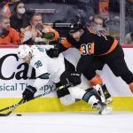 
              San Jose Sharks' Mario Ferraro, left, is checked along the boards by Philadelphia Flyers' Patrick Brown during the second period of an NHL hockey game, Saturday, Jan. 8, 2022, in Philadelphia. (AP Photo/Derik Hamilton)
            
