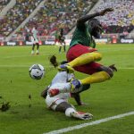 
              Cameroon's Samuel Gouet Oum, top, is tackled by Burkina Faso's Patrick Malo during the African Cup of Nations 2022 group A soccer match between Cameroon and Burkina Faso at the Olembe stadium in Yaounde, Cameroon, Sunday, Jan. 9, 2022. (AP Photo/Themba Hadebe)
            