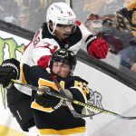 
              New Jersey Devils defenseman Jonas Siegenthaler (71) hooks his stick around the neck of Boston Bruins left wing Brad Marchand (63) during the first period of an NHL hockey game Tuesday, Jan. 4, 2022, in Boston. (AP Photo/Charles Krupa)
            