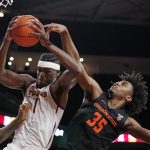 
              Southern California forward Chevez Goodwin, left, grabs a rebound away from Oregon State forward Glenn Taylor Jr. during the second half of an NCAA college basketball game Thursday, Jan. 13, 2022, in Los Angeles. (AP Photo/Mark J. Terrill)
            