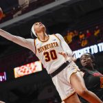 
              Minnesota forward Kayla Mershon (30) goes up for a shot past Maryland guard Ashley Owusu, right, during the first half an NCAA college basketball game Sunday Jan. 9, 2022, in Minneapolis. (AP Photo/Craig Lassig)
            