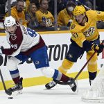 
              Colorado Avalanche left wing Andre Burakovsky (95) skates behind the net as Nashville Predators right wing Michael McCarron (47) chases during the first period of an NHL hockey game Tuesday, Jan. 11, 2022, in Nashville, Tenn. (AP Photo/Mark Zaleski)
            