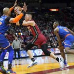 
              Miami Heat's Tyler Herro (14) drives to the basket as New York Knicks center Taj Gibson (67)and guard Immanuel Quickley (5) defend during the second half of an NBA basketball game, Wednesday, Jan. 26, 2022, in Miami. The Heat won 110-96. (AP Photo/Lynne Sladky)
            